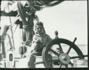 Image of Herbert with pipe at wheel of Bowdoin
